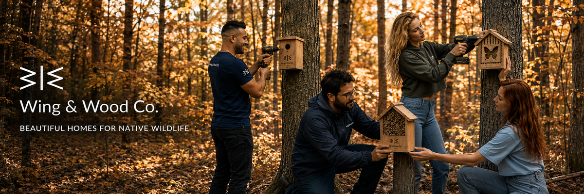 Four people in a wooded outdoor setting installing wooden birdhouses on tree trunks. The scene has warm autumn foliage, and the left side includes the text logo 'Wing & Wood Co.