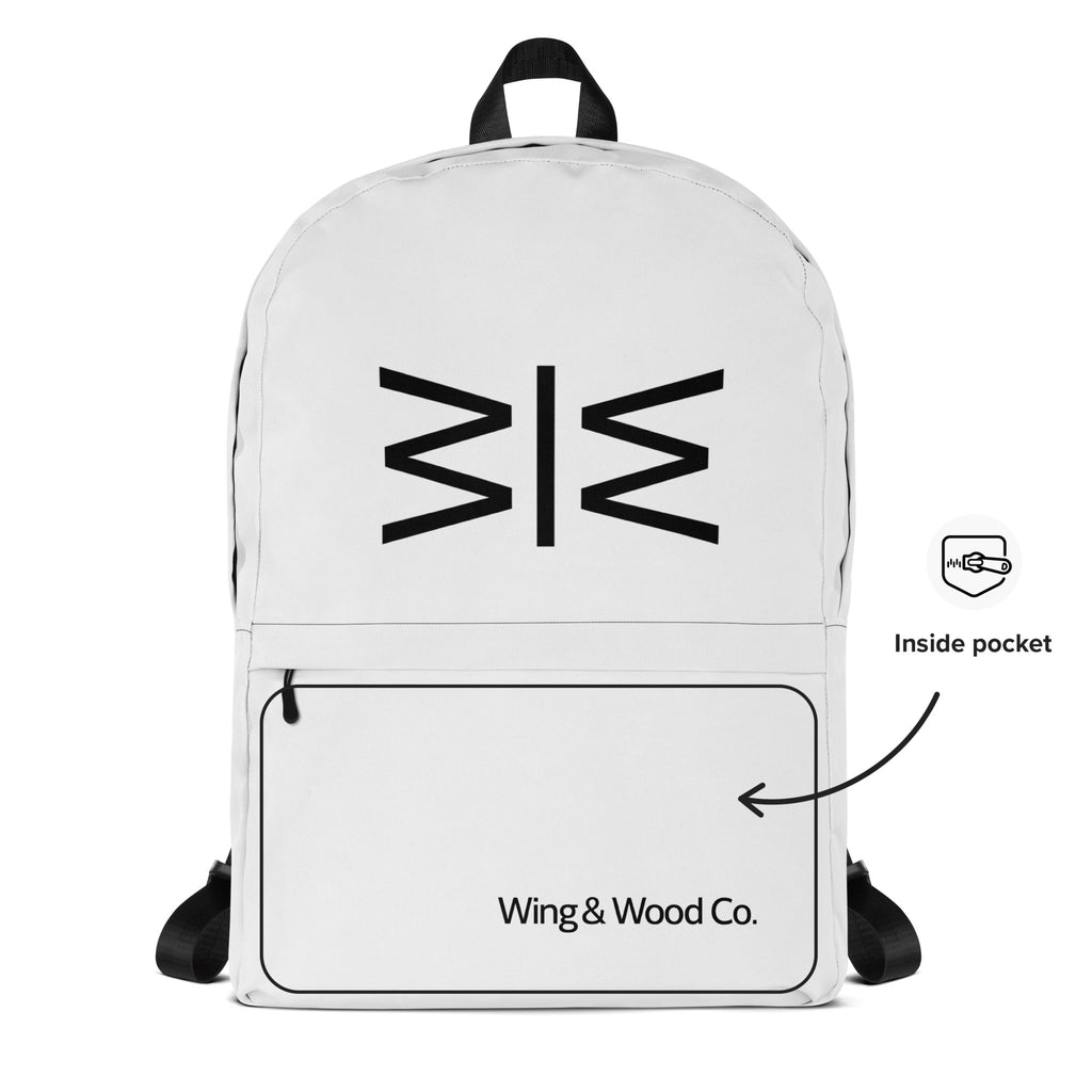 A white backpack with a black geometric logo on the front, a large zippered front pocket printed with 'Wing & Wood Co.', and a black top handle.