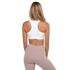 Pastel striped sports bra and pink leggings on a white background