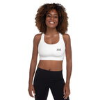 Woman wearing a white sports bra with a logo on a white background