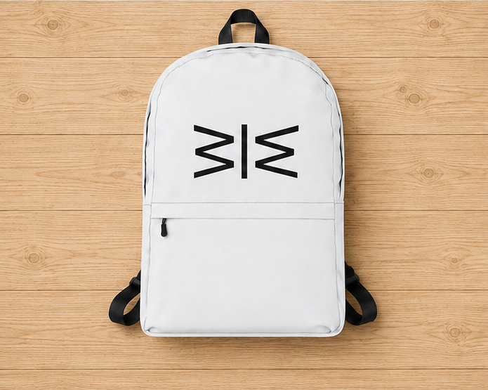 A white backpack with black straps and a black geometric logo on the front, laid flat on a light wood plank background.