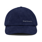 A navy blue corduroy baseball cap with 'Wing & Wood Co.' embroidered in white on the front, shown against a plain white background.