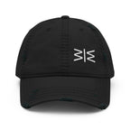 A black distressed baseball cap with a white stylized logo on the front, shown against a plain white background.