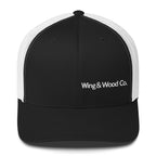 A black and white trucker hat with 'Wing & Wood Co.' embroidered in white on the front panel, shown against a plain white background.