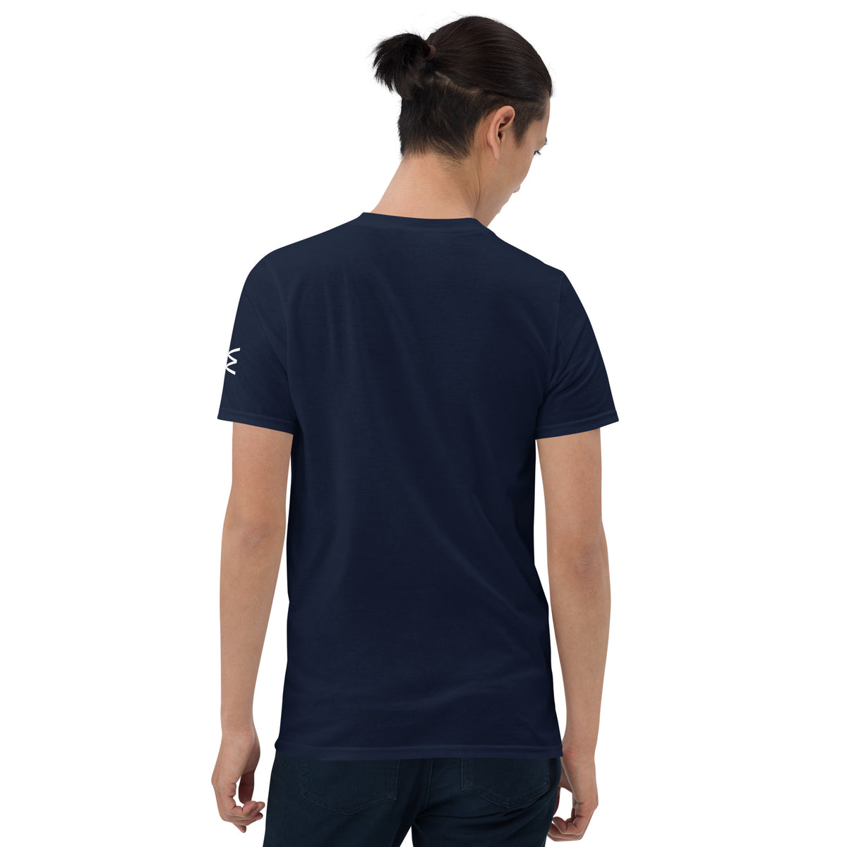 A man viewed from behind wearing a navy blue short-sleeve t-shirt with a small white logo on the left sleeve, set against a plain white background.