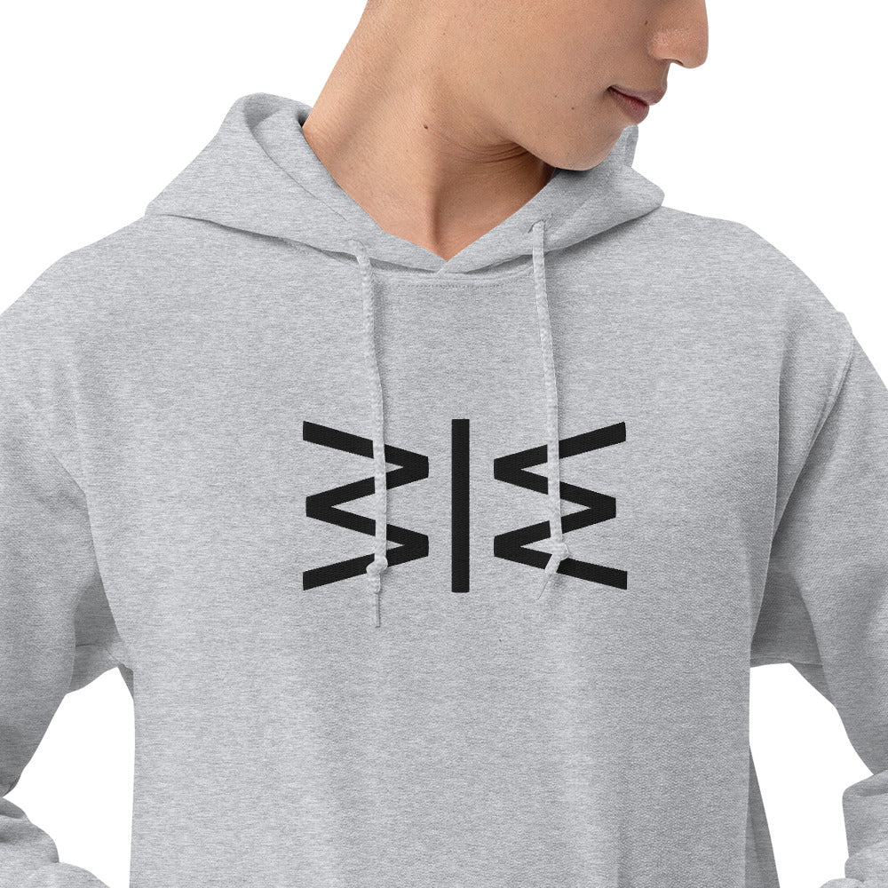 A close-up of a person wearing a light gray pullover hoodie with a black geometric logo printed on the chest, set against a plain white background.