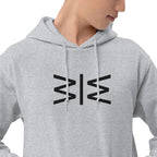 A close-up of a person wearing a light gray pullover hoodie with a black geometric logo printed on the chest, set against a plain white background.