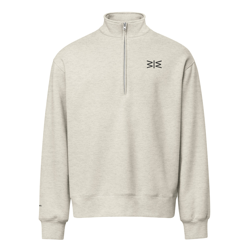 A light heather gray quarter-zip sweatshirt with a small black geometric logo on the left chest, displayed on a solid white background.