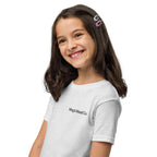Young girl wearing a white t-shirt with a bird design on a white background